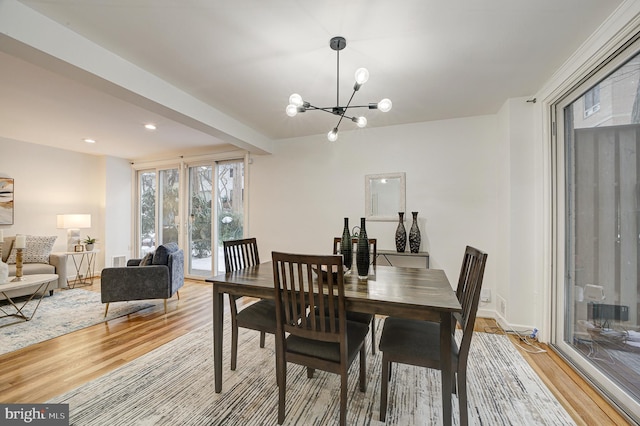 dining area featuring a notable chandelier and light hardwood / wood-style flooring