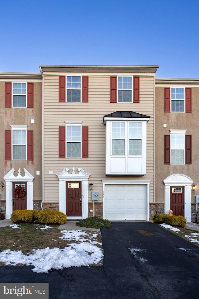 multi unit property featuring a garage