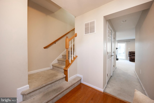 stairs featuring wood-type flooring