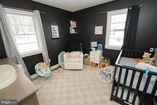 bedroom featuring sink and a nursery area