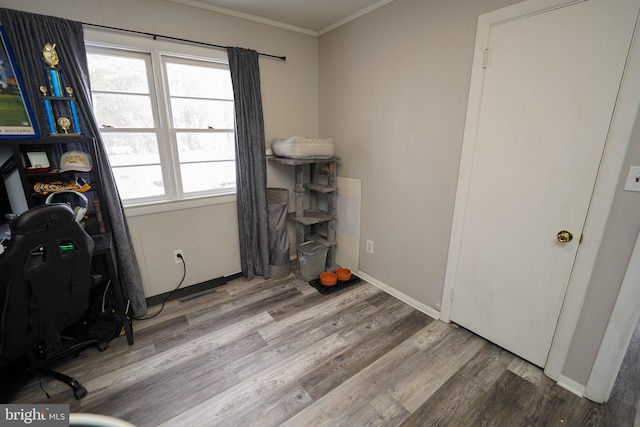 miscellaneous room with hardwood / wood-style floors and ornamental molding