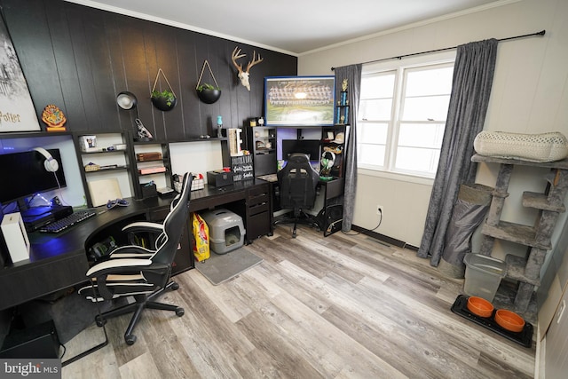 home office with crown molding and light wood-type flooring