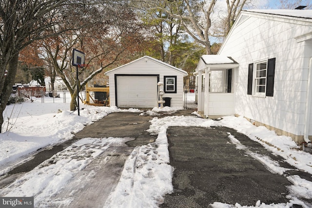 yard covered in snow with an outbuilding and a garage