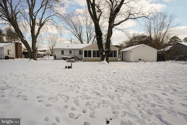 view of snow covered back of property