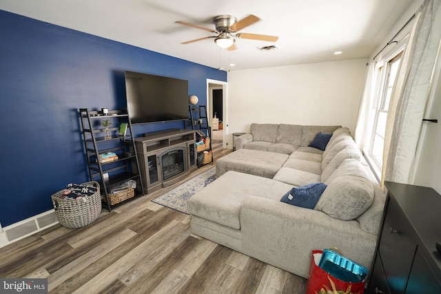 living room with ceiling fan and hardwood / wood-style flooring