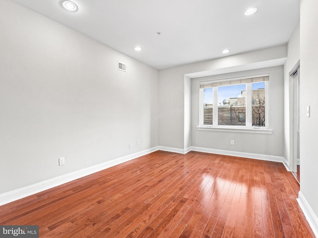 spare room with hardwood / wood-style flooring