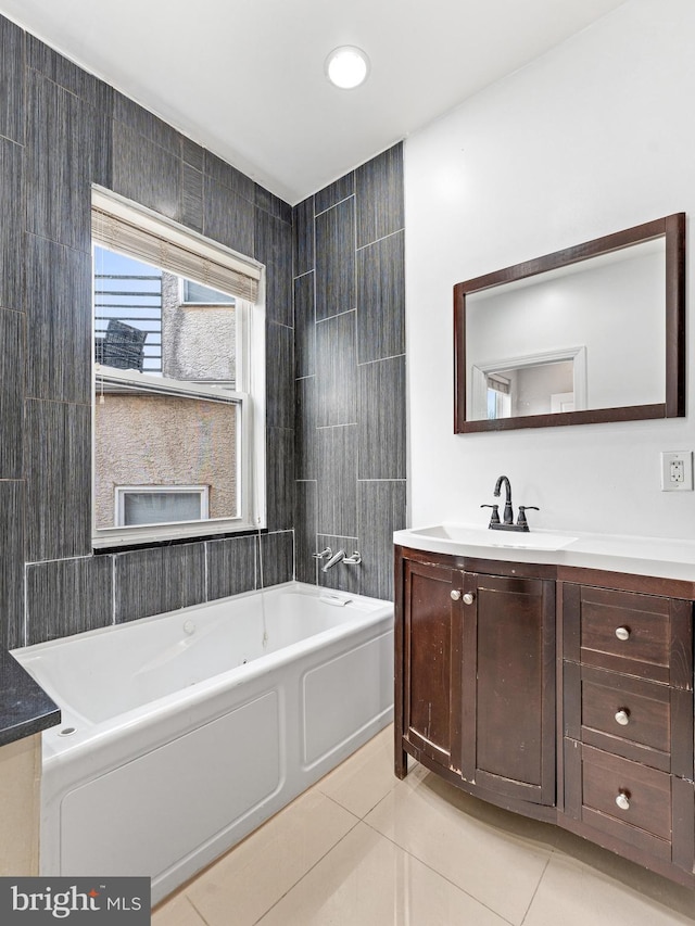 bathroom featuring tile patterned flooring, vanity, shower / bathing tub combination, and tile walls