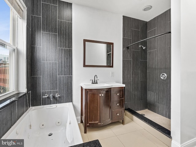 bathroom featuring tile patterned flooring, vanity, tiled shower / bath combo, and plenty of natural light