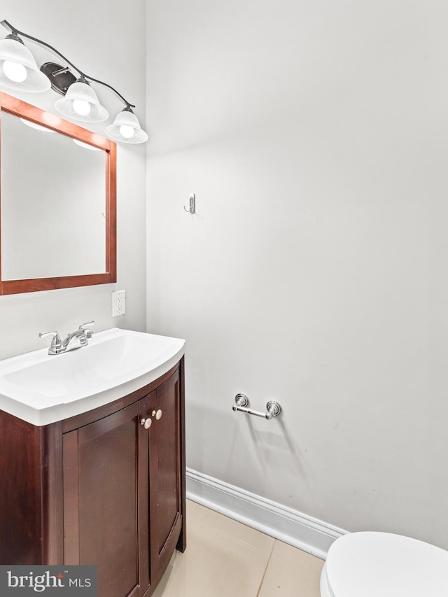 bathroom featuring tile patterned floors, vanity, and toilet