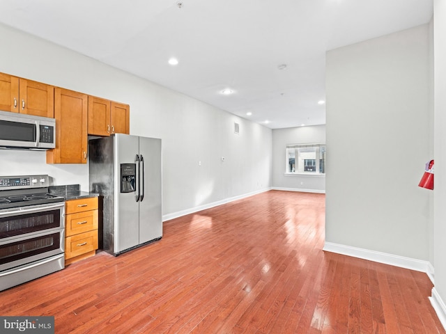 kitchen featuring wood-type flooring and appliances with stainless steel finishes