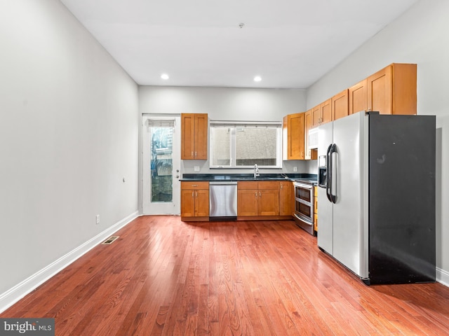 kitchen featuring light hardwood / wood-style floors, sink, and appliances with stainless steel finishes