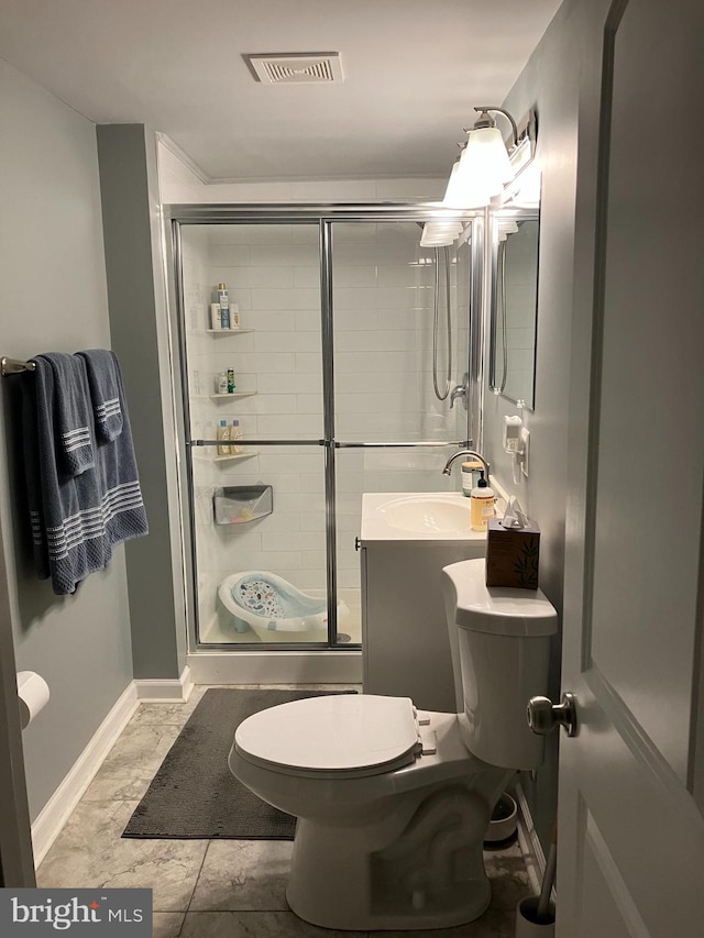 bathroom featuring tile patterned floors, toilet, vanity, and walk in shower