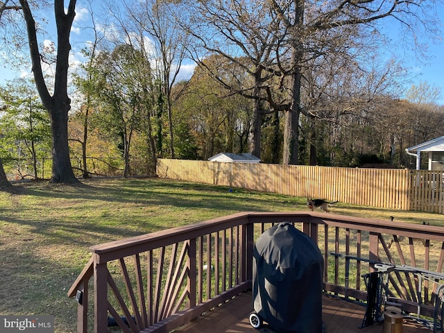 deck featuring grilling area and a yard