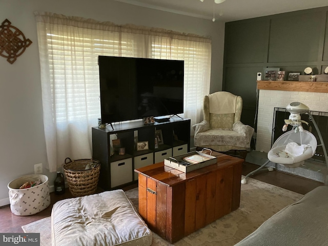 living room with ceiling fan and a brick fireplace