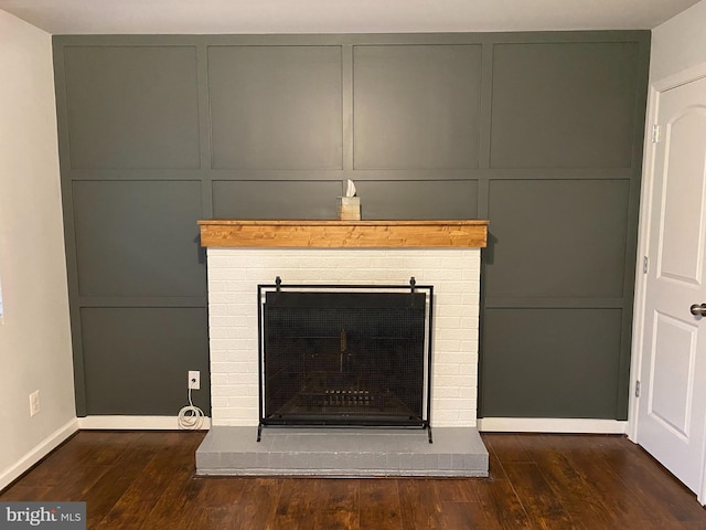 interior details featuring hardwood / wood-style flooring and a fireplace