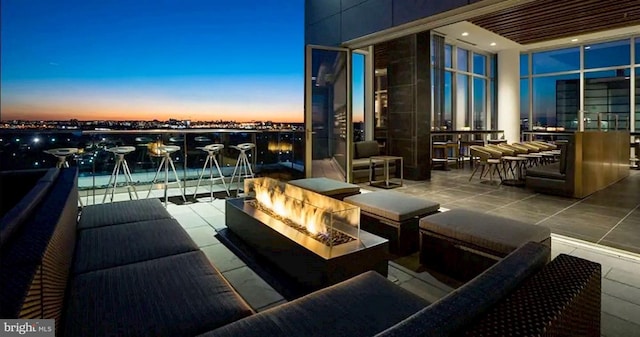 balcony at dusk with a fire pit