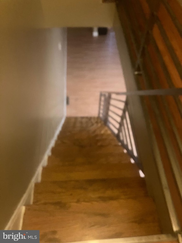 stairs featuring wood-type flooring