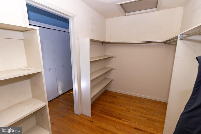 spacious closet featuring hardwood / wood-style flooring