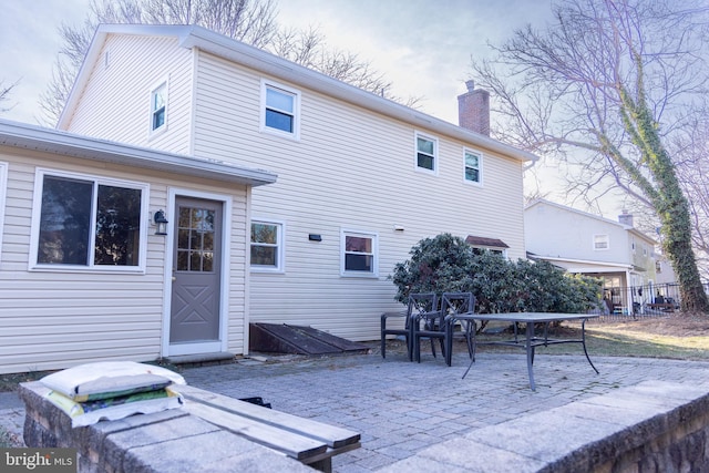 rear view of property featuring a patio area