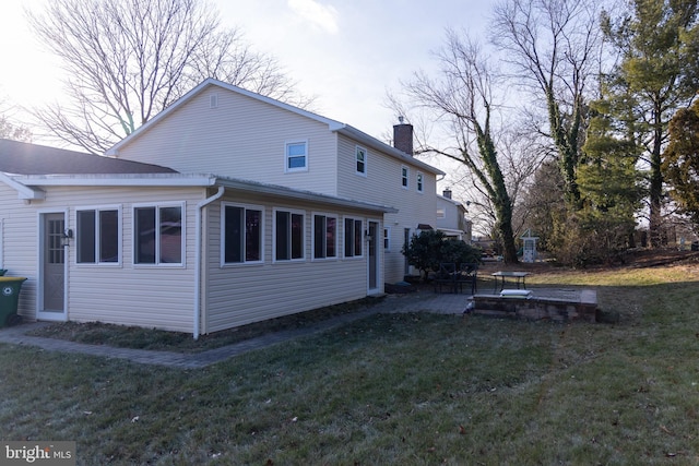 view of home's exterior with a patio and a lawn