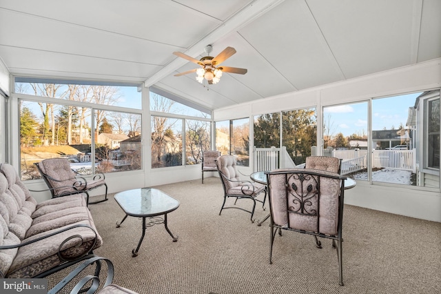 sunroom featuring vaulted ceiling with beams and ceiling fan