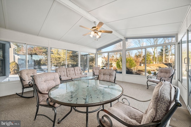 sunroom / solarium with vaulted ceiling with beams, ceiling fan, and a wealth of natural light