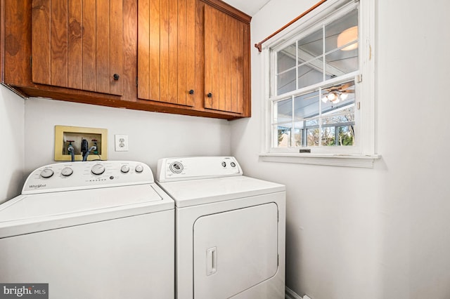 laundry area featuring separate washer and dryer and cabinets