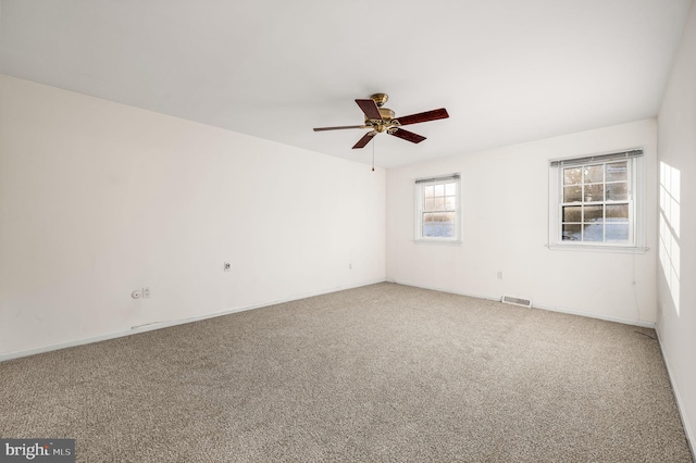 unfurnished room featuring ceiling fan and carpet