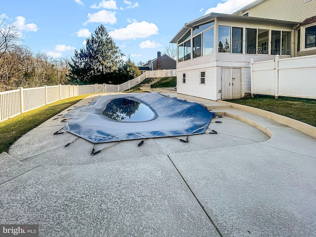 view of pool with a sunroom