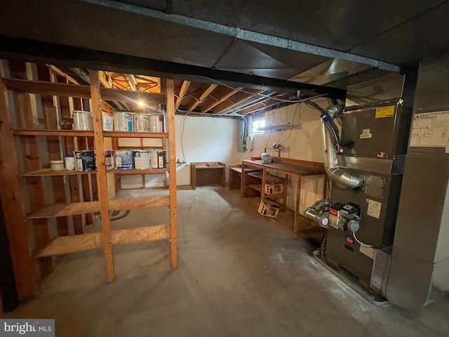 basement with a workshop area and heating unit