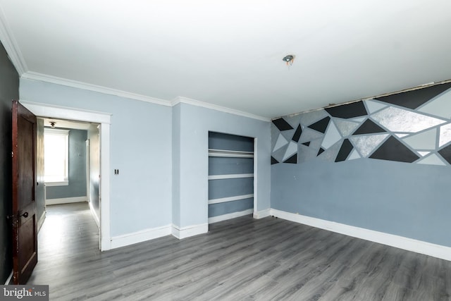 unfurnished room featuring wood-type flooring and ornamental molding