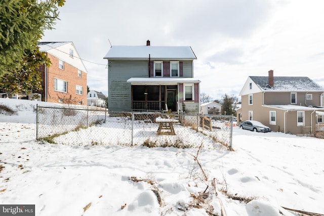 snow covered property with a sunroom