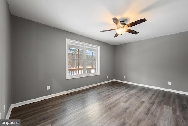 empty room featuring dark hardwood / wood-style floors and ceiling fan