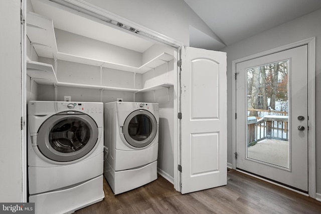 laundry area featuring washer and dryer and dark wood-type flooring