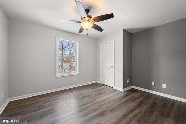 unfurnished bedroom featuring dark hardwood / wood-style floors and ceiling fan