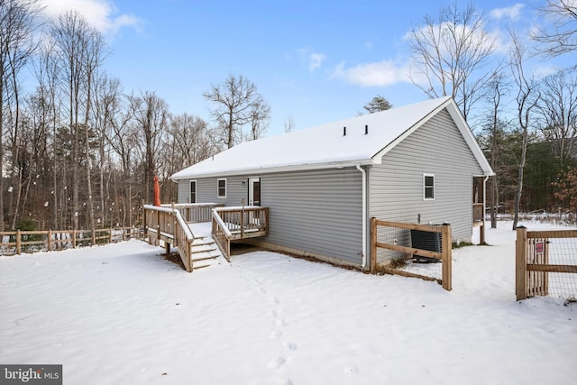 snow covered property with cooling unit