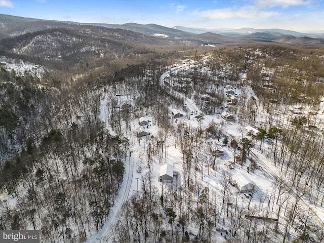 snowy aerial view with a mountain view