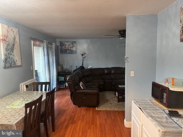 living room featuring ceiling fan and wood-type flooring