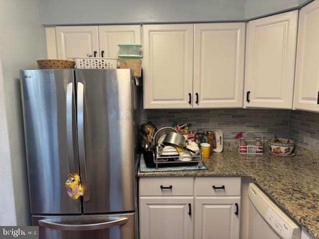 kitchen featuring dishwashing machine, white cabinetry, stainless steel refrigerator, and tasteful backsplash