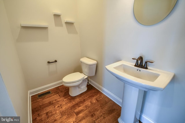 bathroom featuring toilet and hardwood / wood-style floors