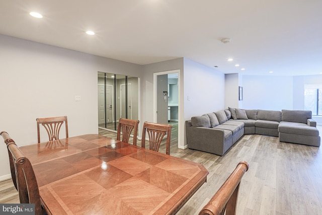 dining space with hardwood / wood-style flooring