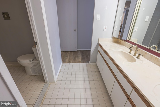 bathroom with tile patterned flooring, vanity, and toilet