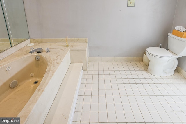 bathroom featuring tile patterned flooring, toilet, and a tub to relax in