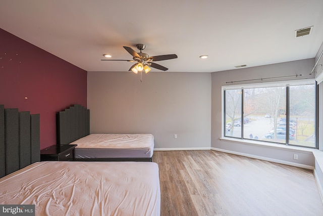 bedroom with light hardwood / wood-style floors and ceiling fan