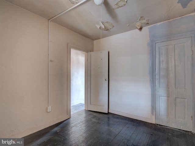 empty room with dark hardwood / wood-style floors