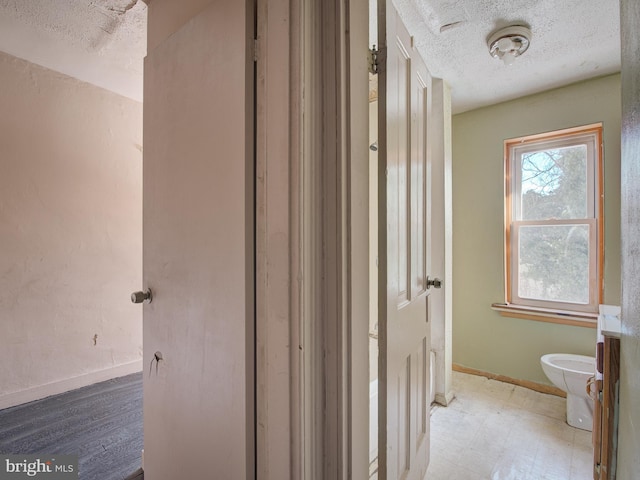 bathroom with vanity, a textured ceiling, and toilet