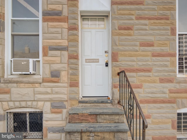 entrance to property featuring cooling unit