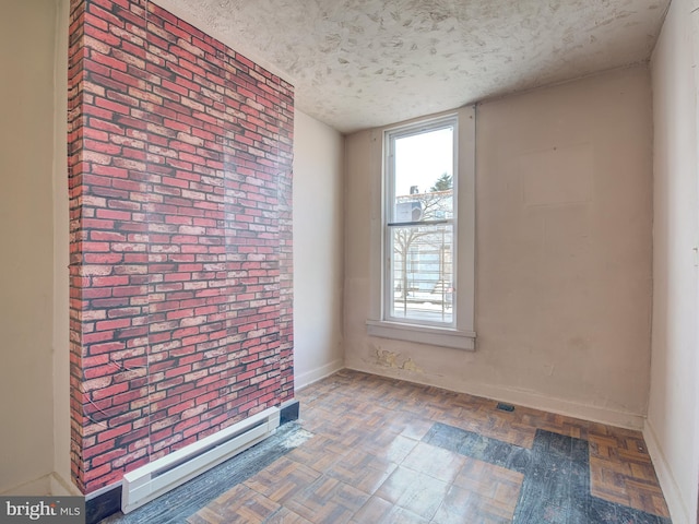 empty room with dark parquet floors, a textured ceiling, and a baseboard radiator