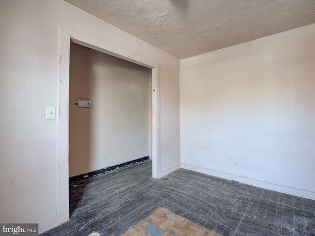 spare room featuring a textured ceiling