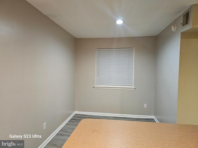 spare room featuring dark wood-type flooring